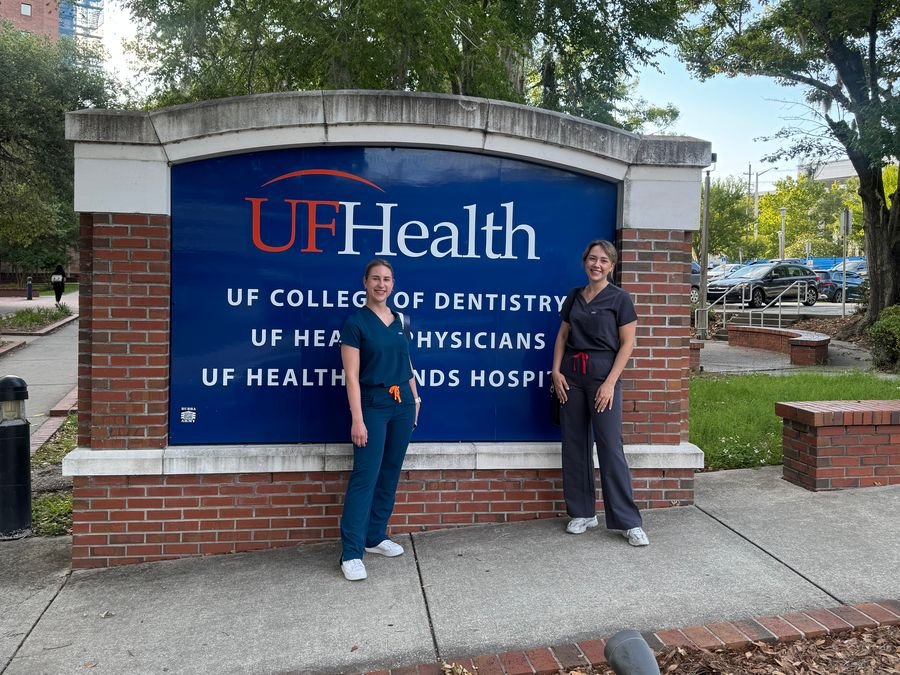 Milda Vitosytė and a colleague by the University of Florida College of Dentistry sign
